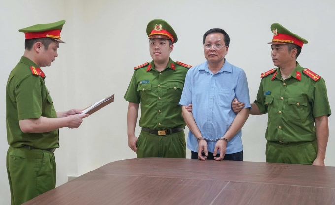 Công an đọc lệnh khởi tố ông Vũ Doanh Nam. Ảnh: Công an cung cấp